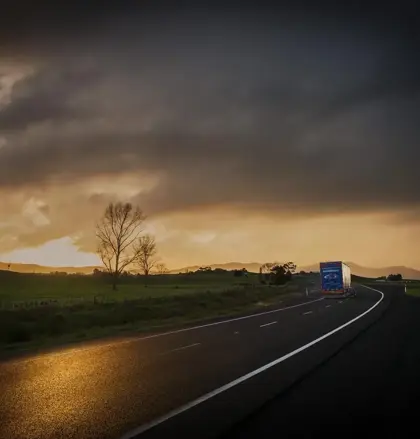 Mainfreight truck on road at sunrise