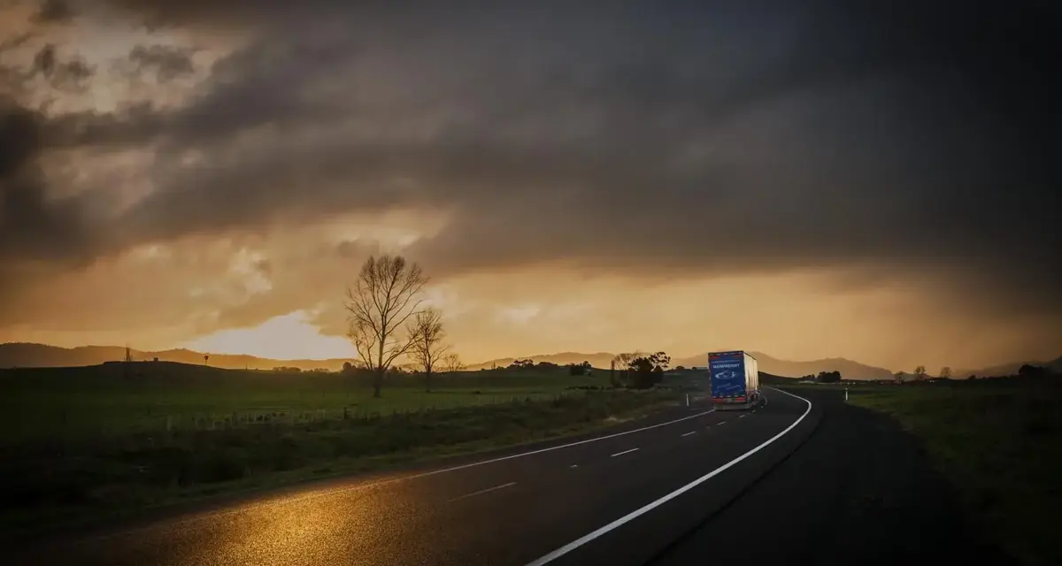 Mainfreight truck on road at sunrise