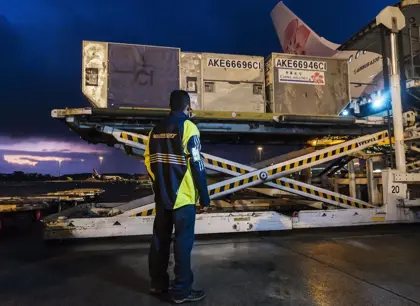 Mainfreight employee watching a load onto an airplane