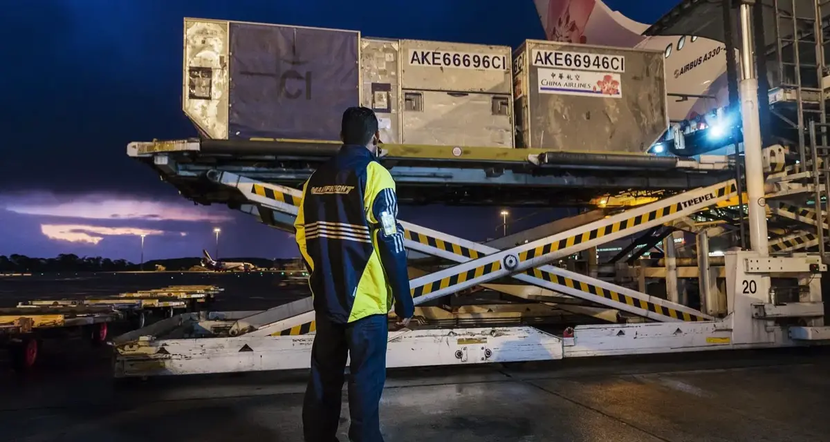 Mainfreight employee watching a load onto an airplane