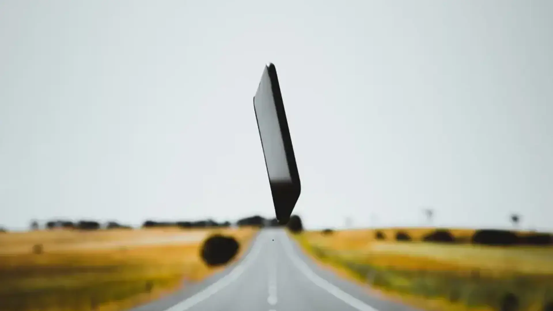 Mobile phone in middle of road in the air