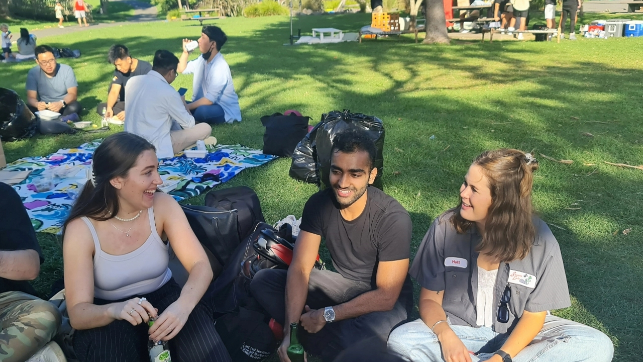 man and two women sitting in park