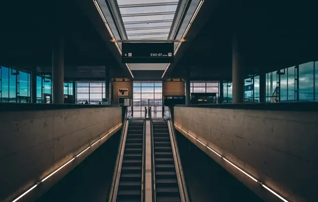 Escalators in airport loading=