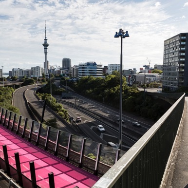 Woman walking across bridge