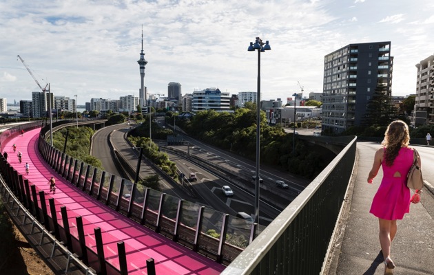 Woman walking across bridge loading=