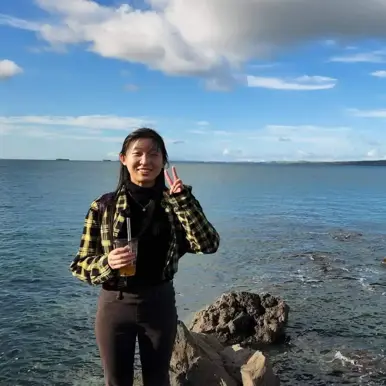 Woman at the beach with coffee