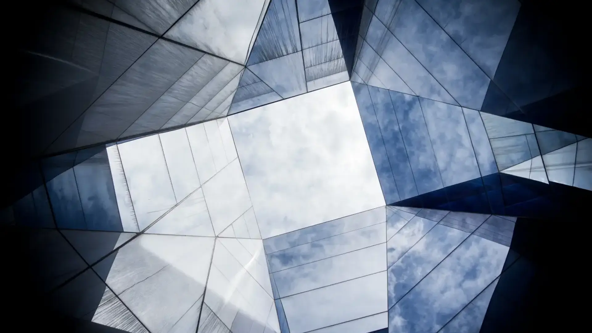 Glass building with cloudy sky